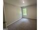 Cozy bedroom with neutral carpeting and a bright window at 20 Emerald Ln # 1, Covington, GA 30014
