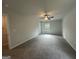 Spacious bedroom with a ceiling fan and plush carpeting, bathed in natural light from a window at 20 Emerald Ln # 1, Covington, GA 30014