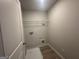 Functional laundry room equipped with shelving and tile flooring for convenience and practicality at 20 Emerald Ln # 1, Covington, GA 30014