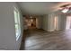 Open-concept living and dining area with wood-look flooring and abundant natural light at 20 Emerald Ln # 1, Covington, GA 30014
