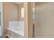 A bright bathroom shows the tub and a peek into a glass door shower at 1960 Morning Nw Walk, Acworth, GA 30102