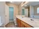 The bathroom has double sinks with a wood cabinet and a view into the walk-in closet at 1960 Morning Nw Walk, Acworth, GA 30102