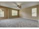 Large bedroom with ceiling fan, gray carpet, and windows with natural light at 1960 Morning Nw Walk, Acworth, GA 30102