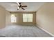 This primary bedroom features neutral walls, carpet flooring, and abundant natural light at 1960 Morning Nw Walk, Acworth, GA 30102