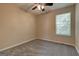 This bedroom has neutral walls, carpet flooring, and a ceiling fan at 1960 Morning Nw Walk, Acworth, GA 30102
