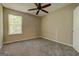 This bedroom has neutral walls, carpet flooring, and a ceiling fan at 1960 Morning Nw Walk, Acworth, GA 30102