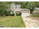 Charming two-story home with stone accents and a two-car garage nestled amongst mature trees at 1960 Morning Nw Walk, Acworth, GA 30102