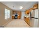 Well-lit kitchen features tile floors, stainless appliances, and oak cabinets at 1960 Morning Nw Walk, Acworth, GA 30102