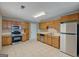 Well-lit kitchen features tile floors, stainless appliances, and oak cabinets at 1960 Morning Nw Walk, Acworth, GA 30102