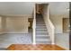 Spacious living room with neutral carpet, staircase access, and a view to adjacent rooms at 1960 Morning Nw Walk, Acworth, GA 30102