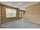 Bright living room features neutral paint, carpeting, large window, and a stairway at 1960 Morning Nw Walk, Acworth, GA 30102