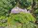 Aerial view of a luxurious property surrounded by lush greenery and mature trees, offering privacy and seclusion at 9255 Betony Wood Trl, Jonesboro, GA 30236