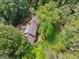Aerial view of a beautiful home nestled among dense trees, showcasing its secluded location and verdant surroundings at 9255 Betony Wood Trl, Jonesboro, GA 30236