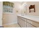 Neutral bathroom with a large mirror, and plenty of counter space at 9255 Betony Wood Trl, Jonesboro, GA 30236