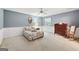 Carpeted bedroom with bed, rocking chair, and neutral tones at 9255 Betony Wood Trl, Jonesboro, GA 30236