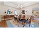 Bright dining room with a wooden table, decorative chandelier, and wainscoting accents at 9255 Betony Wood Trl, Jonesboro, GA 30236