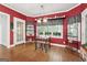 Sun-filled dining area boasts a chandelier, three windows, and decorative shelving at 9255 Betony Wood Trl, Jonesboro, GA 30236