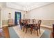 Elegant dining room with a large wooden table, chandelier lighting, and detailed trim work at 9255 Betony Wood Trl, Jonesboro, GA 30236