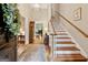 Inviting foyer with hardwood floors, staircase, elegant lighting, and views into the formal living spaces at 9255 Betony Wood Trl, Jonesboro, GA 30236
