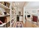 Hallway with floor to ceiling bookshelves, a wet bar, and wood floors at 9255 Betony Wood Trl, Jonesboro, GA 30236