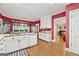 Bright kitchen featuring white cabinets, stainless appliances, and wood floors at 9255 Betony Wood Trl, Jonesboro, GA 30236