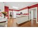 Open kitchen featuring a large island, white cabinets, and wood flooring at 9255 Betony Wood Trl, Jonesboro, GA 30236