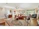 Spacious living room with wood floors, a red leather couch, and natural light at 9255 Betony Wood Trl, Jonesboro, GA 30236