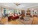 Large living room features wood floors, a fireplace, built-in bookcases, and a ceiling fan at 9255 Betony Wood Trl, Jonesboro, GA 30236