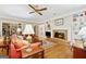 Cozy living room with fireplace, built-in bookshelves, and wood flooring at 9255 Betony Wood Trl, Jonesboro, GA 30236