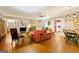 Open-concept living room boasts wood floors, fireplace, built-in shelving, and a ceiling fan at 9255 Betony Wood Trl, Jonesboro, GA 30236