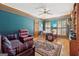 Spacious office with blue walls, a ceiling fan, and natural light at 9255 Betony Wood Trl, Jonesboro, GA 30236