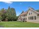 A spacious home with a sprawling green backyard and deck, framed by large, mature trees offering privacy and shade at 1029 Ector Nw Dr, Kennesaw, GA 30152