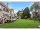 Expansive backyard featuring a lush lawn, a wooden deck, and a playground set, ideal for outdoor activities at 1029 Ector Nw Dr, Kennesaw, GA 30152