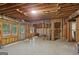 Unfinished basement featuring exposed wooden beams, concrete flooring, and natural light from the windows at 1029 Ector Nw Dr, Kennesaw, GA 30152