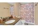 Cozy bathroom featuring a granite countertop, patterned shower curtain, and neutral wall color at 1029 Ector Nw Dr, Kennesaw, GA 30152