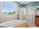 Bright bathroom features an oval soaking tub, separate glass enclosed shower, and a large window at 1029 Ector Nw Dr, Kennesaw, GA 30152