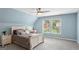 Comfortable bedroom featuring plush carpeting, two windows, a ceiling fan, and soothing blue walls at 1029 Ector Nw Dr, Kennesaw, GA 30152
