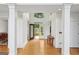 Inviting foyer featuring elegant columns, gleaming hardwood floors, and a decorative glass front door at 1029 Ector Nw Dr, Kennesaw, GA 30152