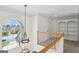 Light-filled hallway with a decorative light fixture, and large windows providing a view of the street at 1029 Ector Nw Dr, Kennesaw, GA 30152