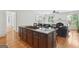 Open kitchen with island cooktop, stainless appliances and breakfast bar seating open to the living area at 1029 Ector Nw Dr, Kennesaw, GA 30152