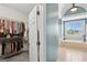 Walk-in closet leading to a bathroom with a soaking tub under a bright window at 1029 Ector Nw Dr, Kennesaw, GA 30152