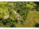 Aerial view of a property featuring a house with a pool, surrounded by lush trees and a well-maintained landscape at 316 Gaithers Rd, Mansfield, GA 30055