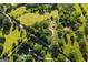 Expansive aerial view of a lush, green property showcasing mature trees, open fields, and a tranquil rural setting at 316 Gaithers Rd, Mansfield, GA 30055