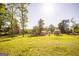 Expansive backyard with green lawn, featuring small animal pens and a natural, scenic setting at 316 Gaithers Rd, Mansfield, GA 30055