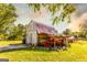 Exterior shot of rustic barn with a faded red metal roof and weathered wood, surrounded by a green lawn at 316 Gaithers Rd, Mansfield, GA 30055