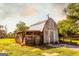 Rustic barn featuring weathered wood, a metal roof, and vintage charm on a grassy lot at 316 Gaithers Rd, Mansfield, GA 30055
