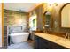Stylish bathroom with a soaking tub, double sink vanity, and wood accent walls at 316 Gaithers Rd, Mansfield, GA 30055