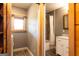Bathroom view with tiled shower/bath, marble vanity, and a glimpse into the laundry room at 316 Gaithers Rd, Mansfield, GA 30055