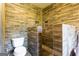 Modern bathroom featuring a toilet, shower with unique stone flooring and tiled walls at 316 Gaithers Rd, Mansfield, GA 30055