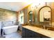 Beautiful bathroom with a soaking tub, double sink vanity, and a unique accent wall at 316 Gaithers Rd, Mansfield, GA 30055